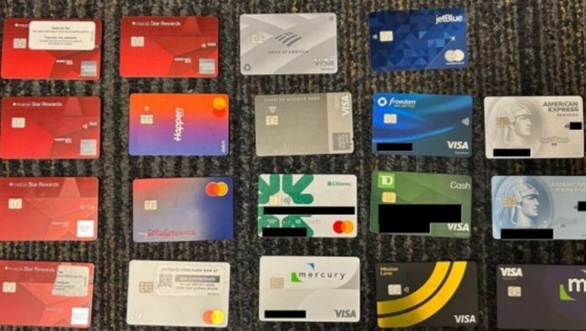 Credit and debit cards federal agents say were stolen are displayed on a table at Fort Lauderdale-Hollywood International Airport Monday, Aug. 31, 2026.